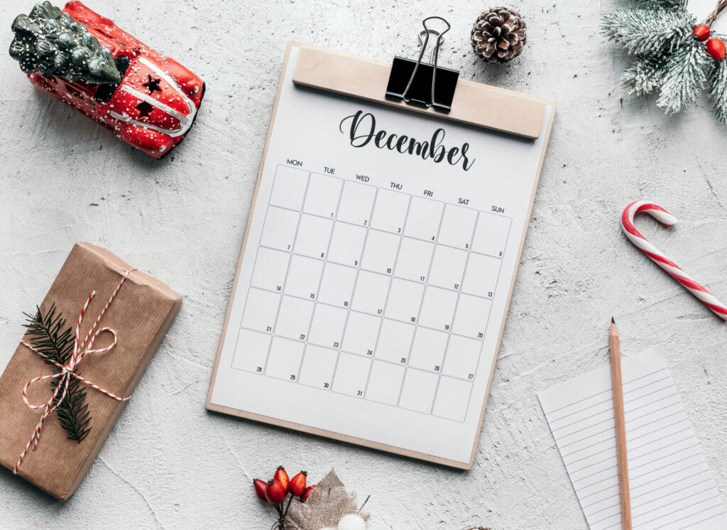 a December calendar and a pencil on a table